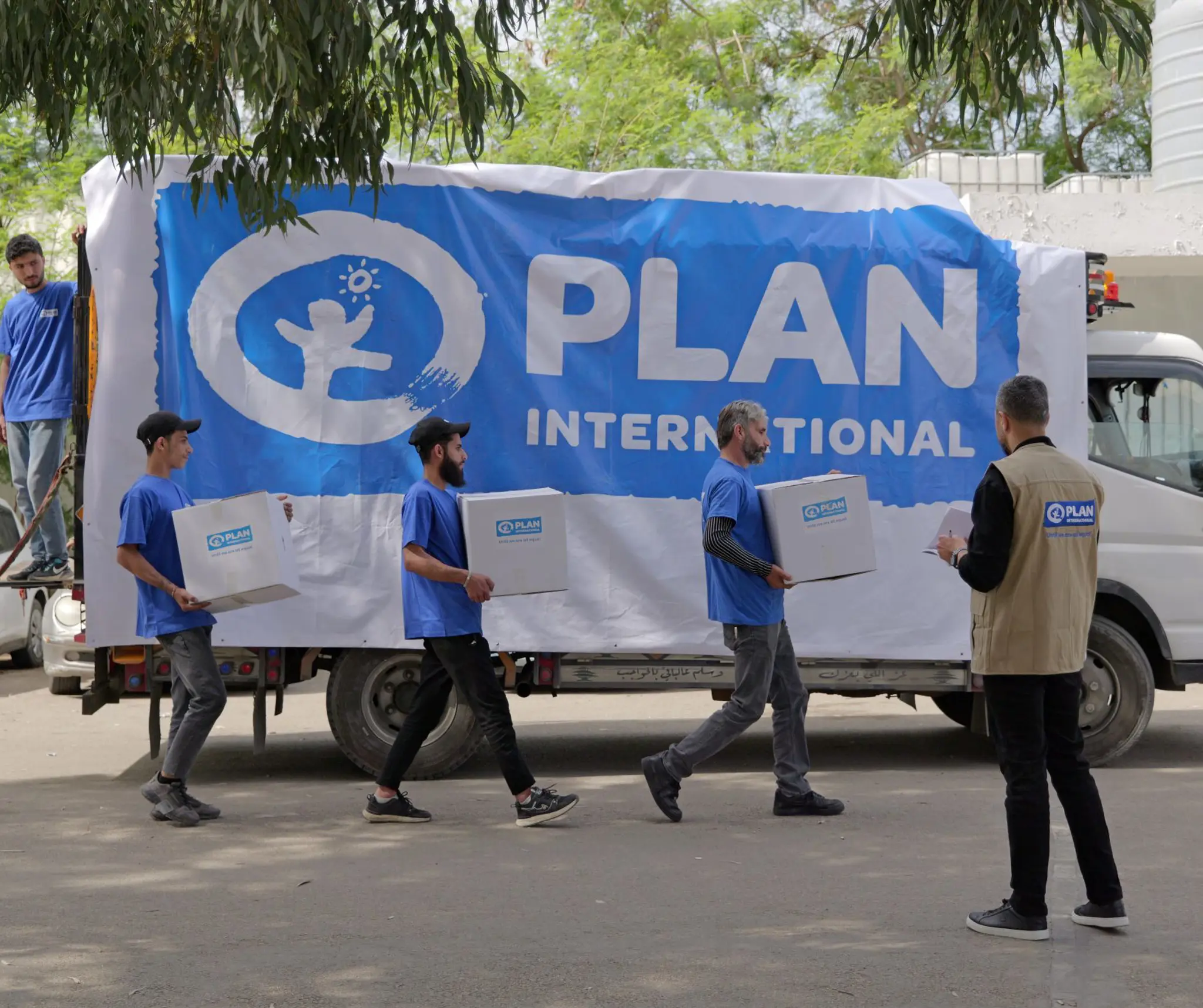 Medarbejder fra plan international pakker lastbil